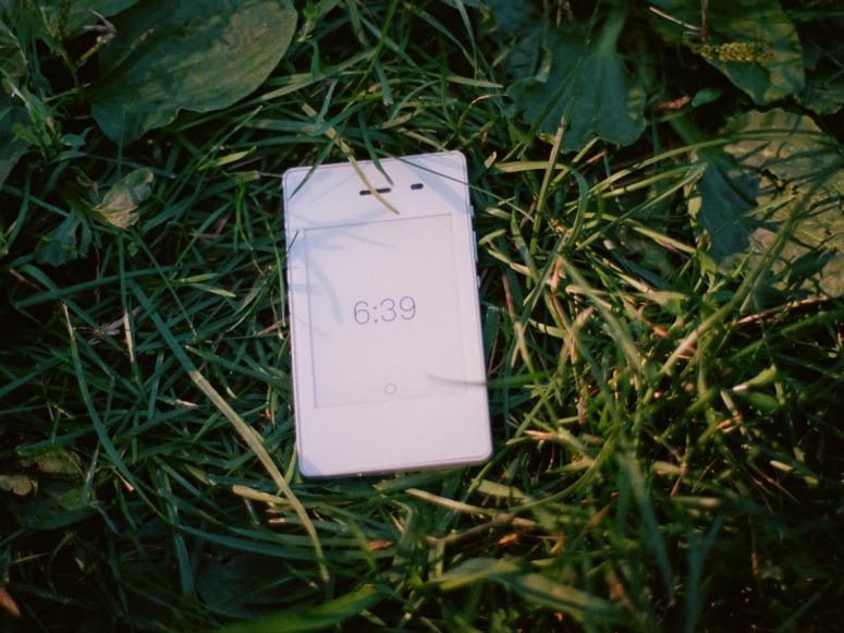 A white Light Phone in grass.