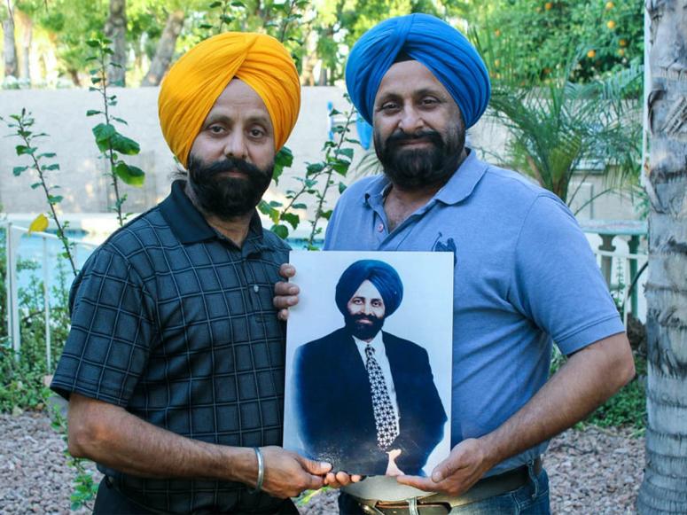 Rana and Harjit Sodhi holding a photo of their late brother, Balbir Singh Sodi, who died on 9/11