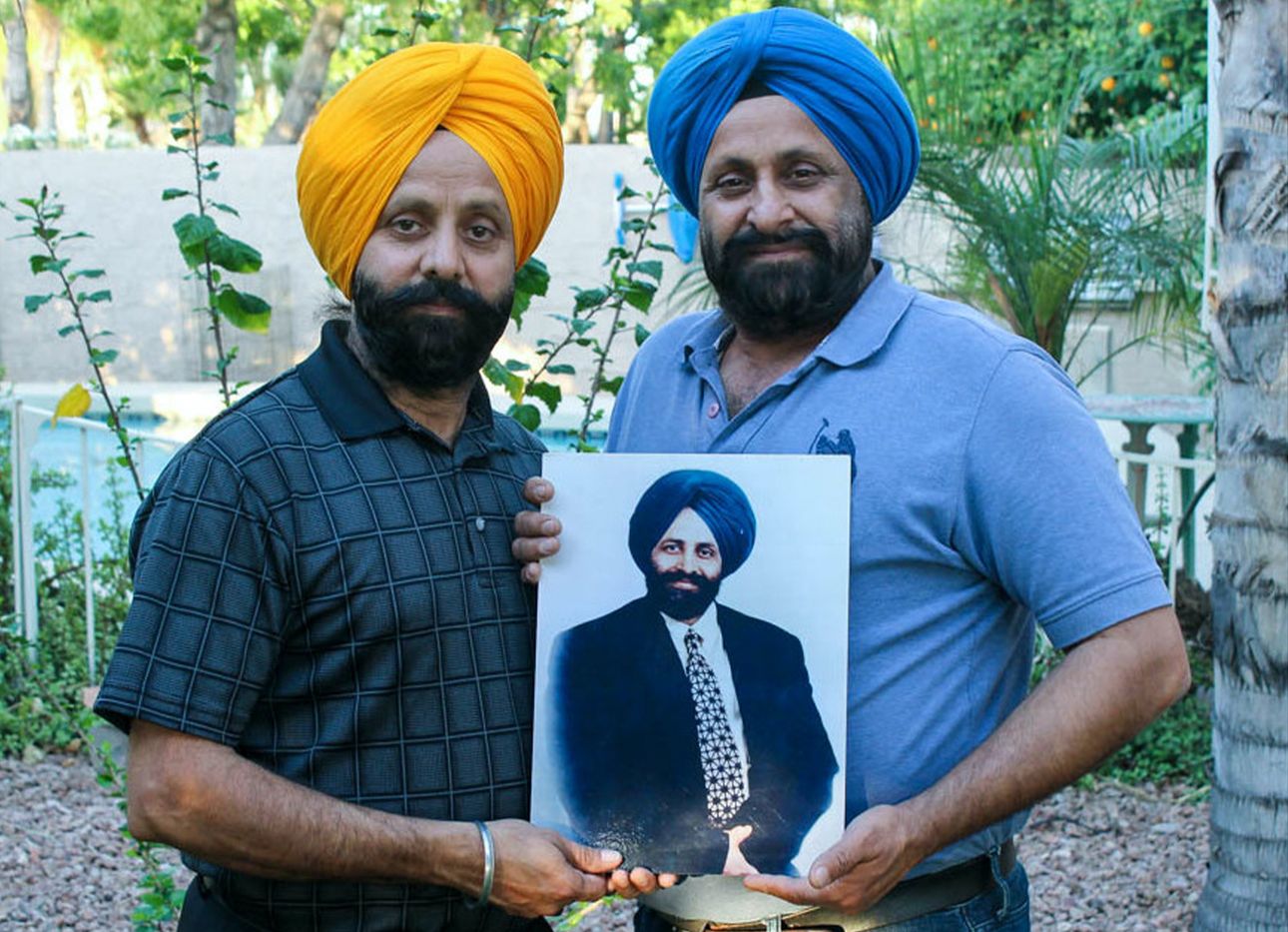 Rana and Harjit Sodhi holding a photo of their late brother, Balbir Singh Sodi, who died on 9/11