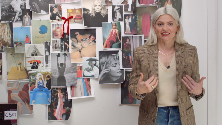 Stylist Kate Young stands in front of a mood board