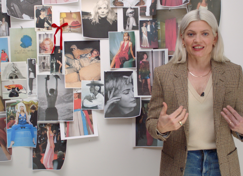 Stylist Kate Young stands in front of a mood board