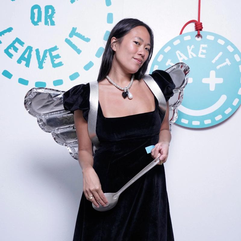 New York–based fashion stylist and shop owner Beverly Nguyen with the pair of silver inflatable wings she won at “Take It or Leave It.” (Photo: Mattia Gargioni) 