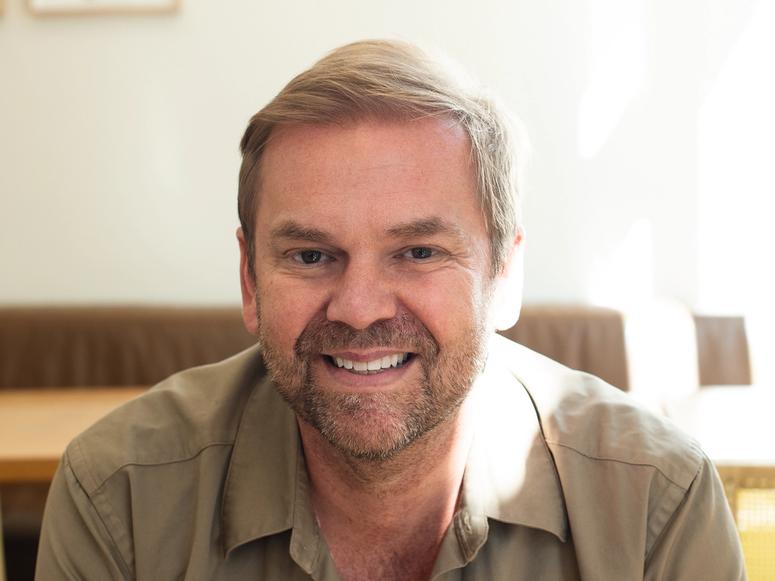 Chef Bill Granger smiling in a sunny room.