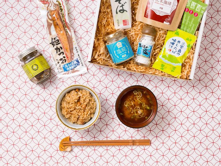 A Kokoro Care Package open to show its contents on a patterned white and red background.