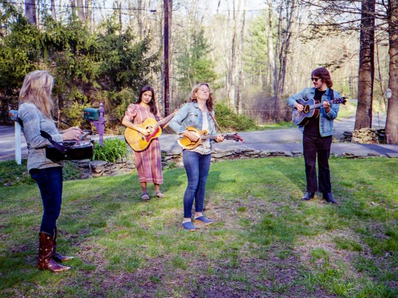 Amy Helm and the Curbside Pickup Band playing music on a front lawn.