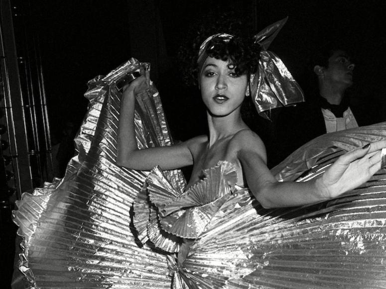 A photo of a dancer in a glittering dress, from inside Studio 54.