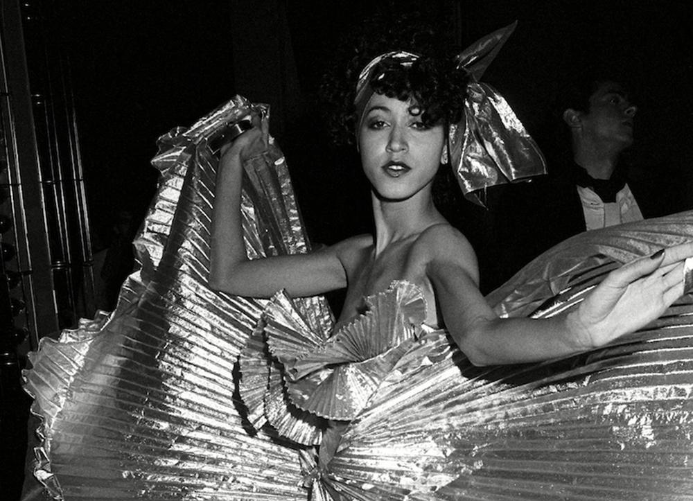 A photo of a dancer in a glittering dress, from inside Studio 54.