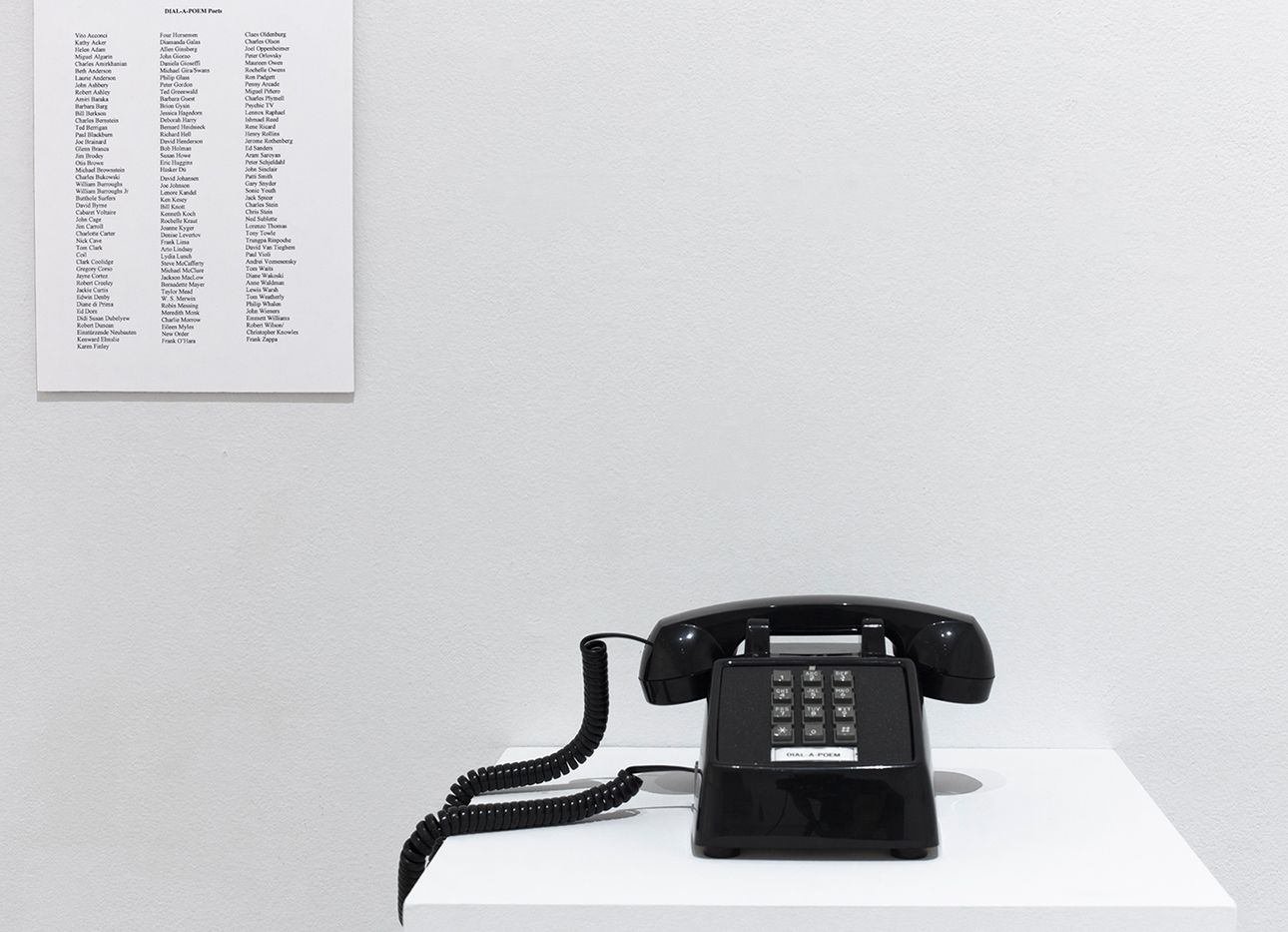Giorno's Dial-a-Poem phone in a white gallery setting.