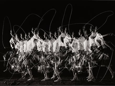 Black and white photo of a woman jumping rope