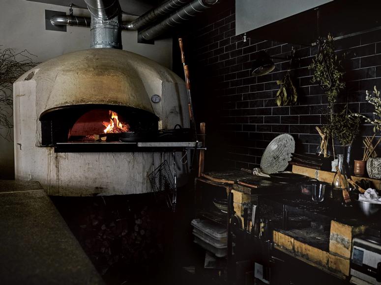 A wood-fired oven in a kitchen.