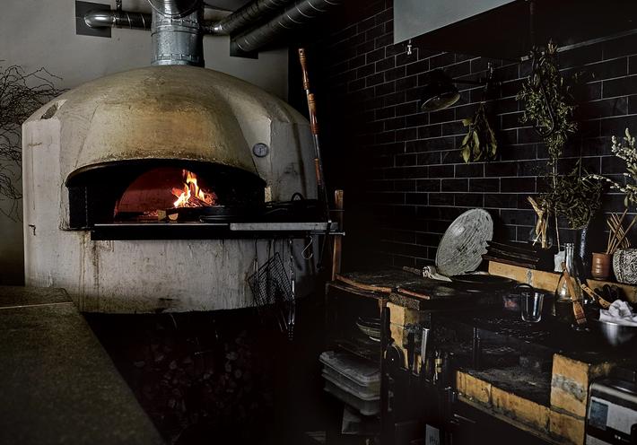 A wood-fired oven in a kitchen.