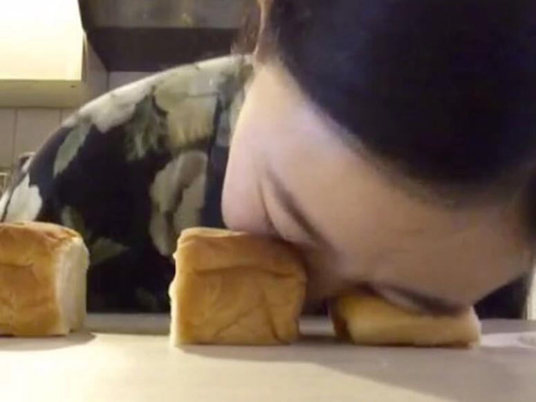 A woman face-down on two rolls, in a grainy screenshot.