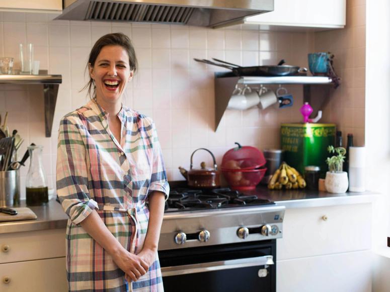 Mina Stone laughing in her kitchen.