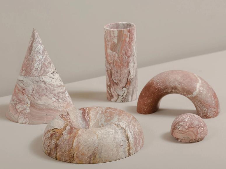 Rodrigo Bravo's pink marble vessels in various shapes.