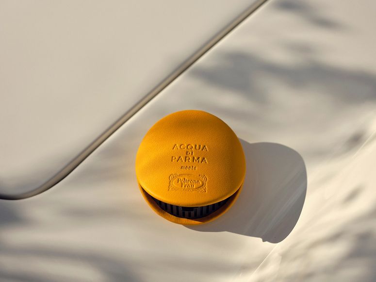 Yellow air freshener on car dashboard
