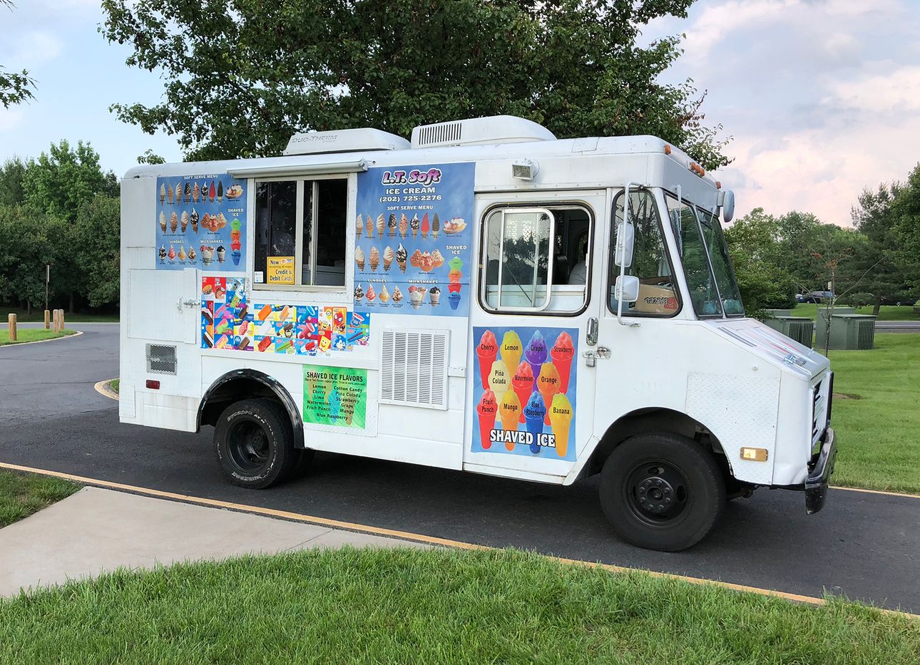 A classic ice cream truck in the summer.