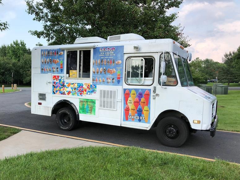 A classic ice cream truck in the summer.
