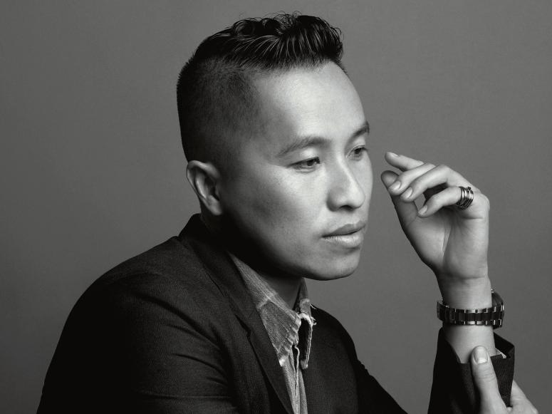 Fashion designer Phillip Lim in profile, in a suit, in a black and white photograph.