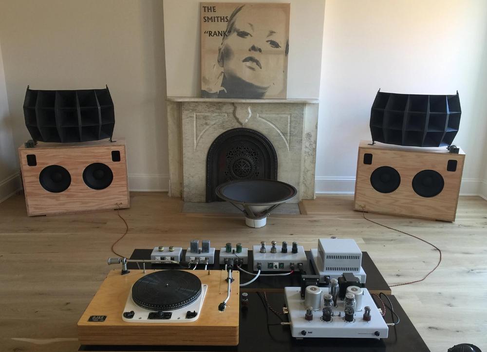 Ojas speakers, amplifiers, and turntable in an NYC apartment.