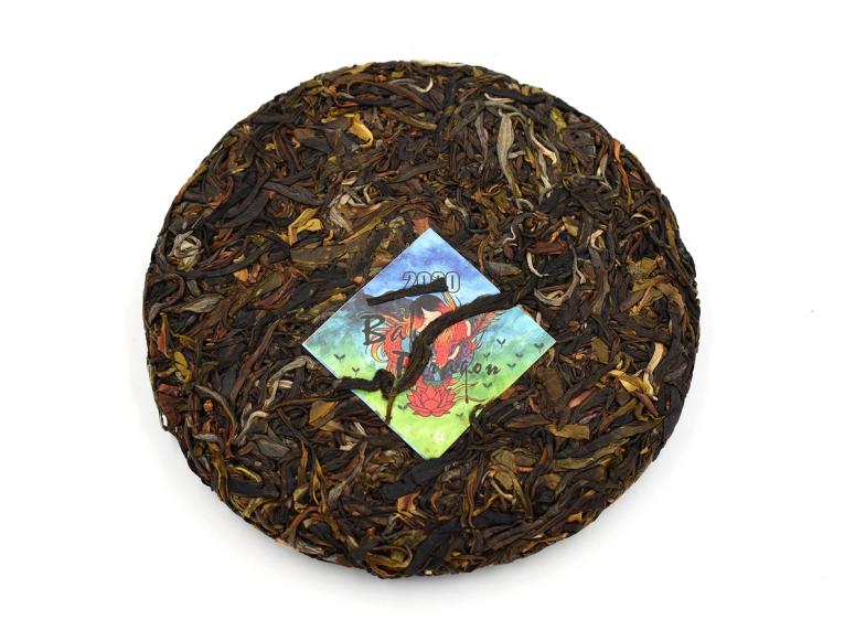 A cake of dried pu-erh with a colorful tag.