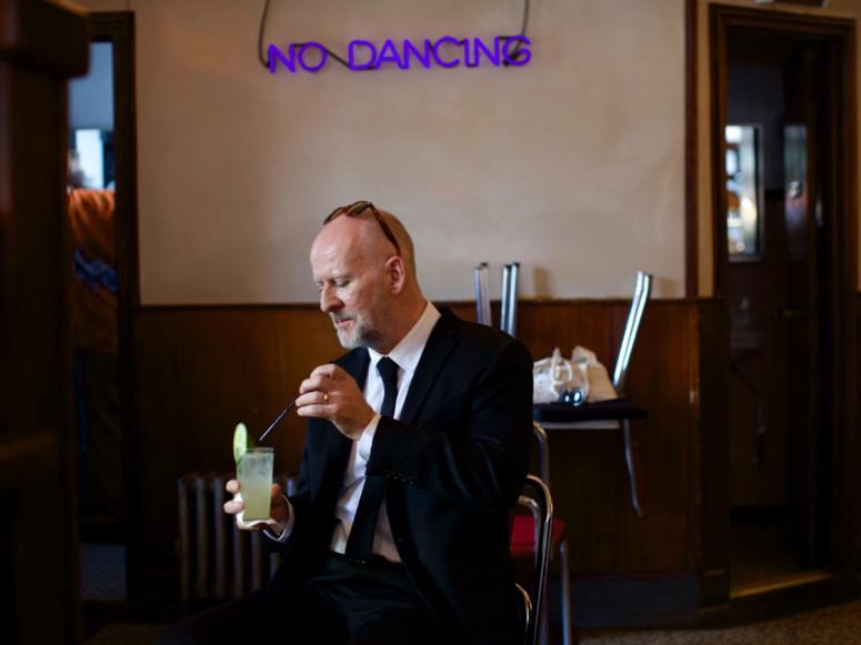 Philosopher Simon Critchley having a drink at a bar