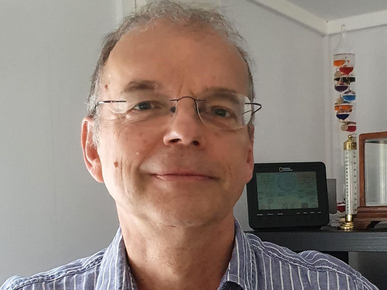 A man wearing glasses and a striped shirt