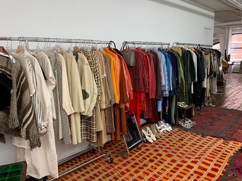 The interior of Object Limited, with racks of clothes along a wall.