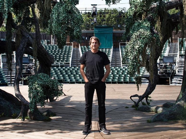 David Rockwell standing in an amphitheater.