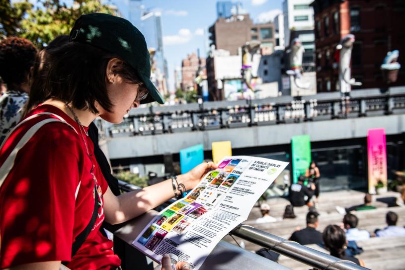 A visitor reading the event program. (Courtesy Emerson Collective)