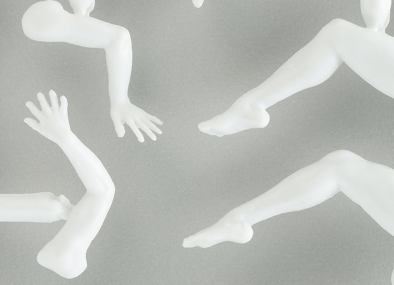 Disembodied plastic limbs on a grey background.