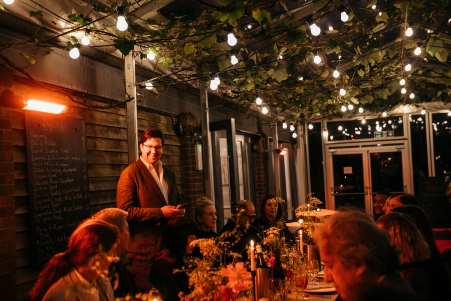 September 24, 2025, London | The Slowdown’s editor-in-chief, Spencer Bailey, toasts the 12th season of our Time Sensitive podcast during an intimate dinner at the restaurant Rochelle Canteen in London’s Shoreditch neighborhood, with guests including architect John Pawson, interior and furniture designer Ilse Crawford, and critic Alice Rawsthorne. (Photo: Iona Wolff)