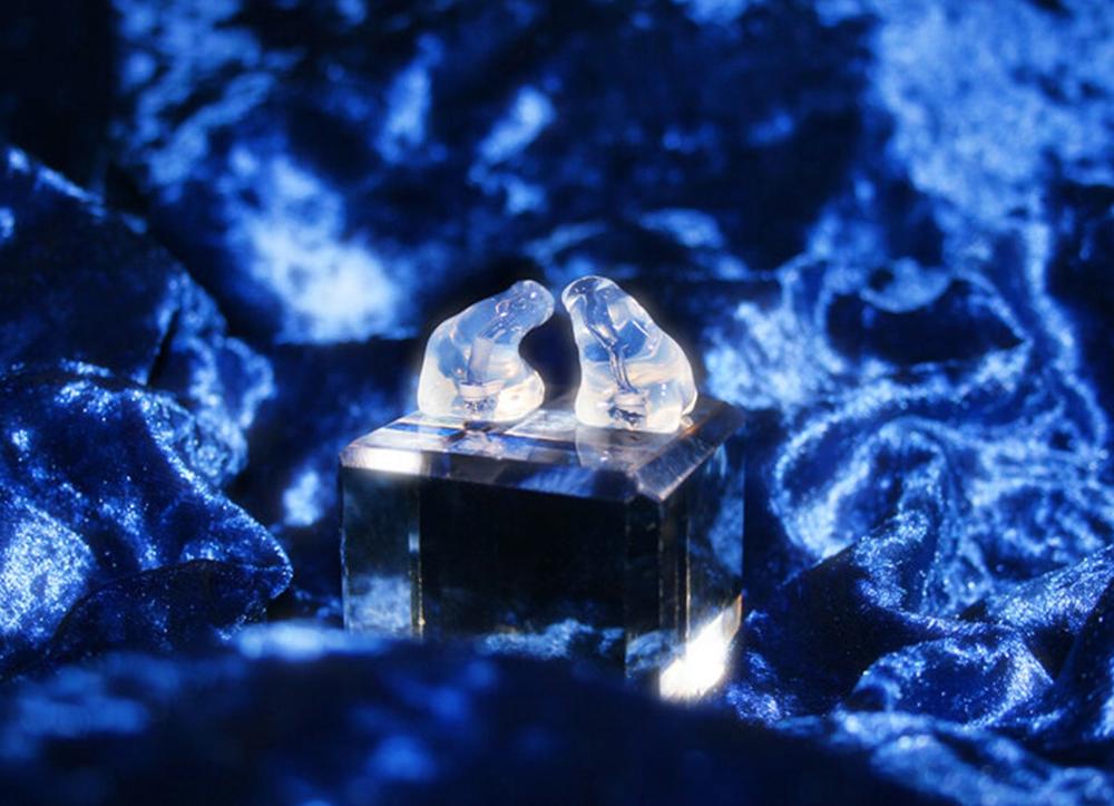 Silicone earplugs against a blue velvet background