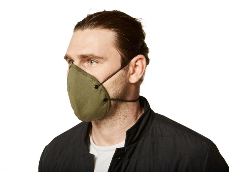 A man wearing an army green face mask.