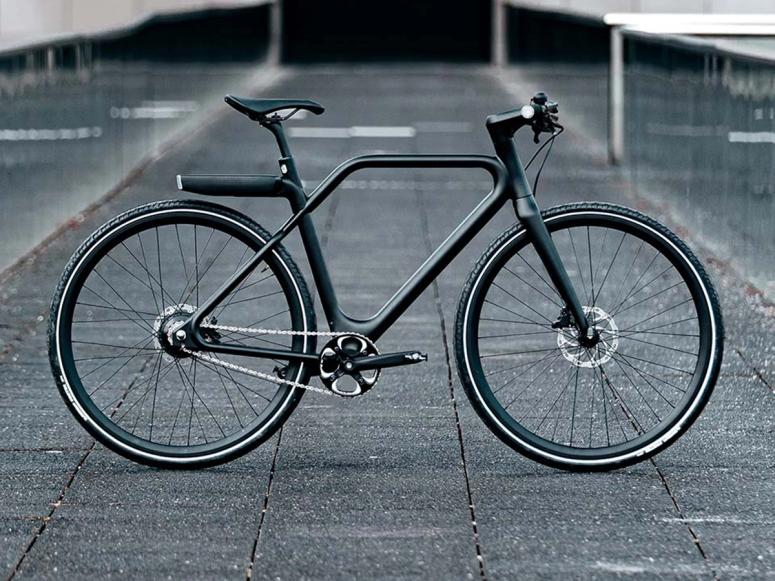 A black Angell bike on concrete in profile.