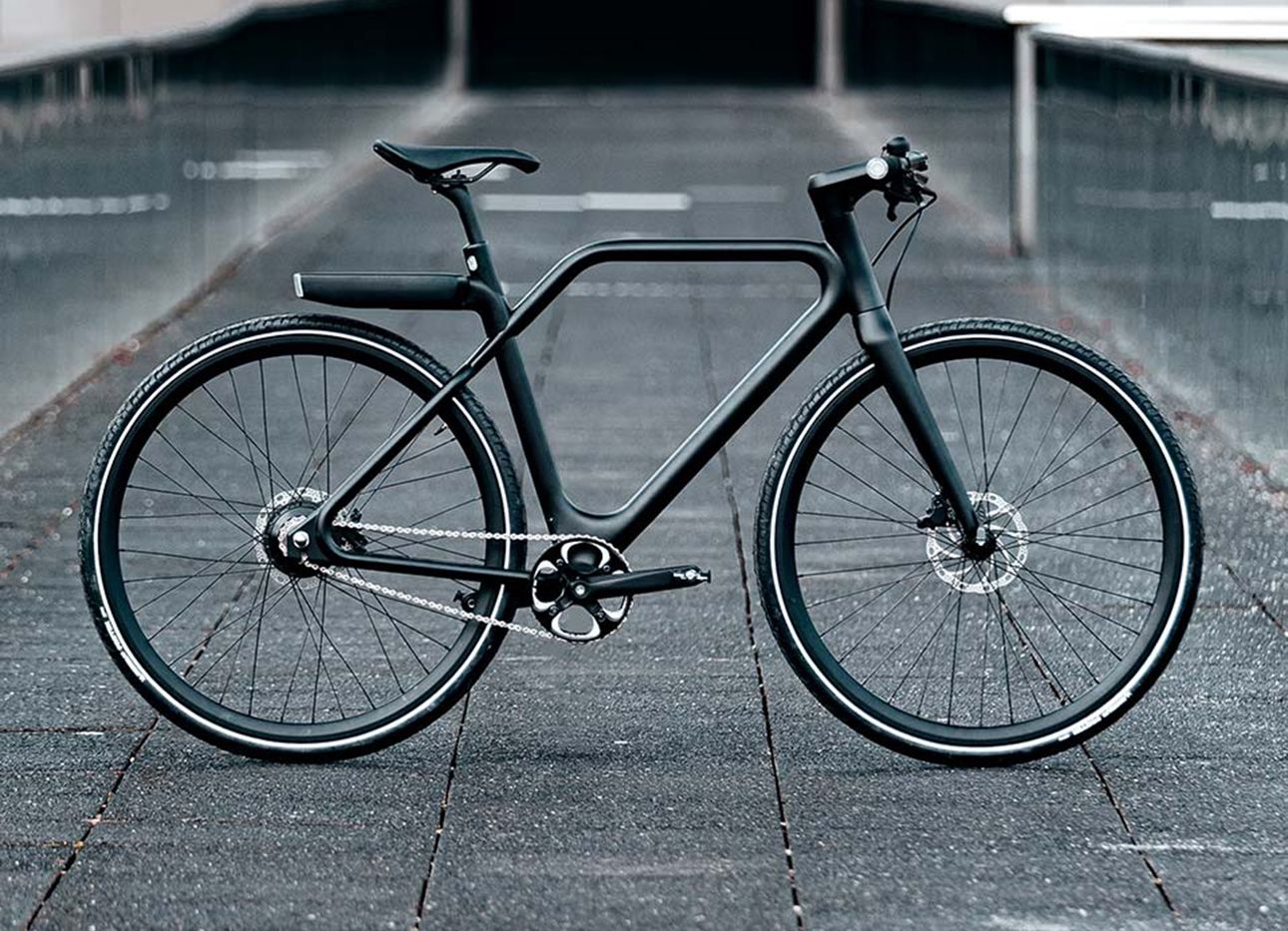 A black Angell bike on concrete in profile.