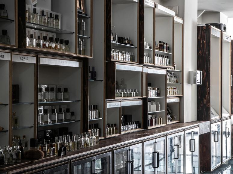 The interior of a fragrance boutique, with many bottles lined up on shelves.