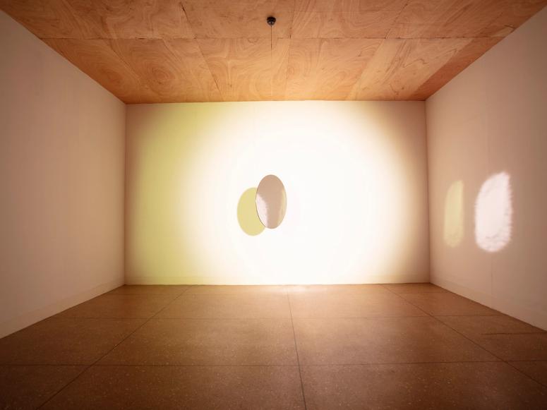 Olafur Eliasson's installation "Tell Me About a Miraculous Invention," involving a mirror and light in a gallery.