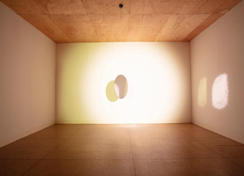Olafur Eliasson's installation "Tell Me About a Miraculous Invention," involving a mirror and light in a gallery.