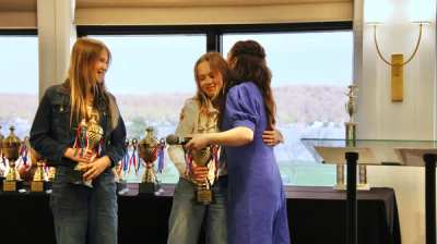 Athletes collecting trophies at the indoor awards night