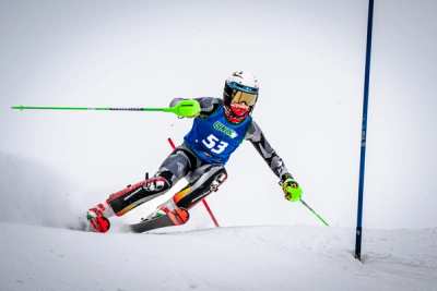 Racer wearing bib 53 committing to a slalom turn