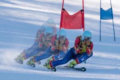 Multiple-exposure sequence of one racer passing through a giant slalom gate