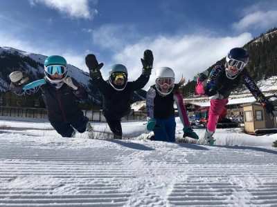 Four athletes jumping in the air together at the base area