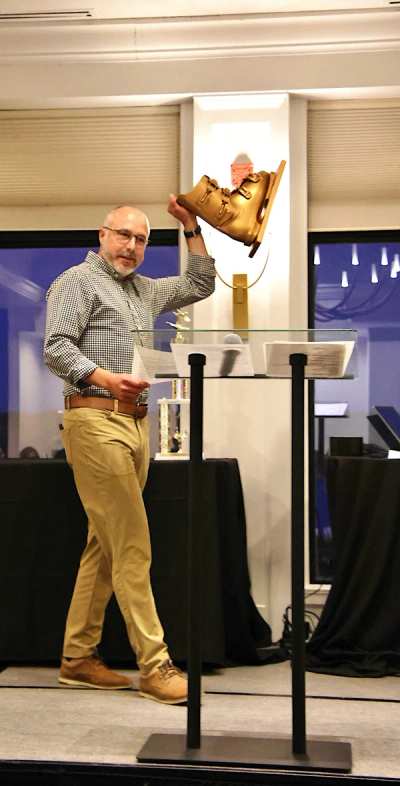 Coach raising a trophy at the end-of-season banquet