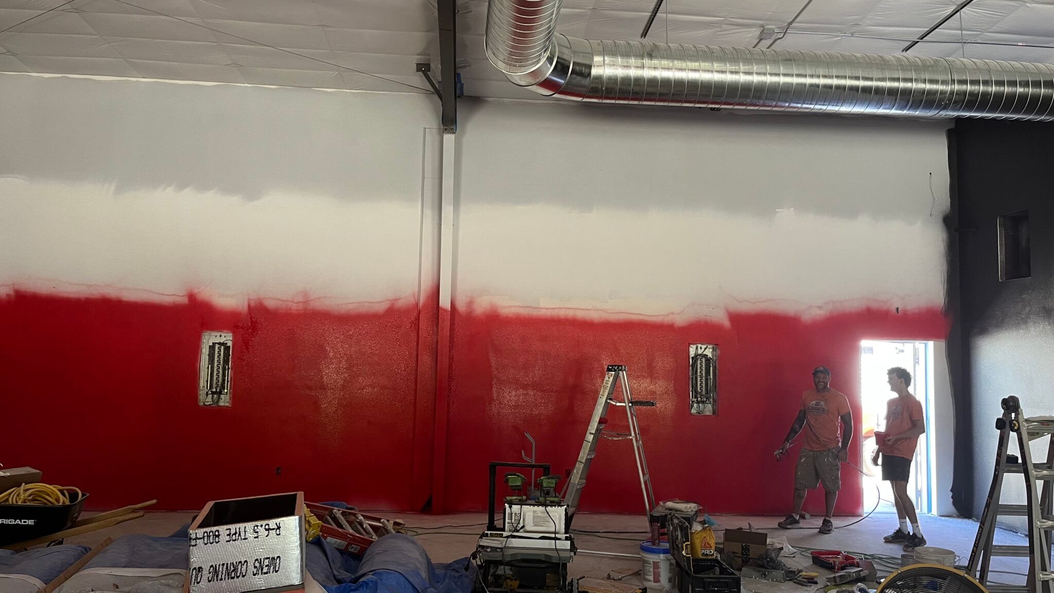 Painting the room red at The Iron Village gym.