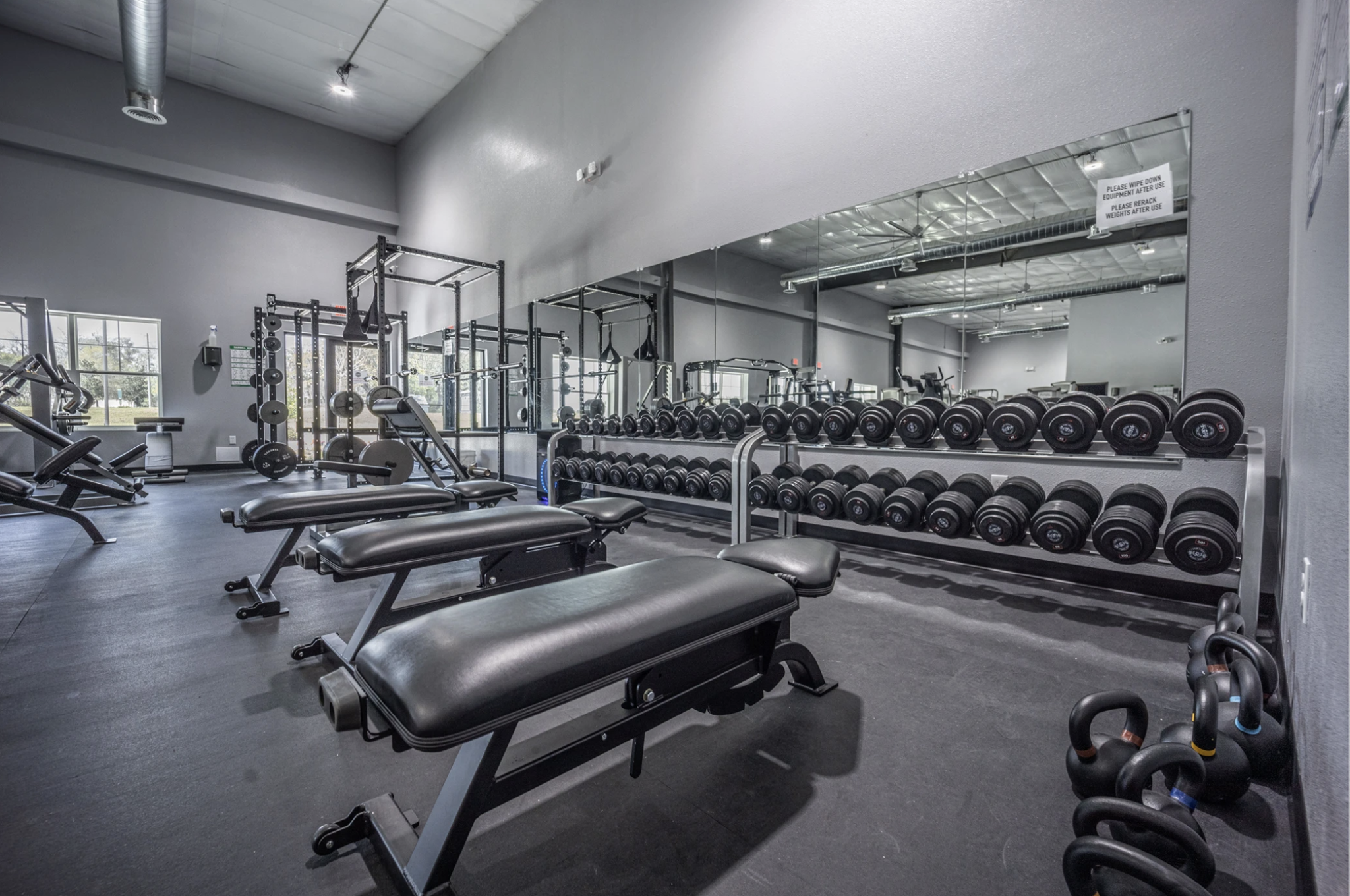 Workout benches, free weights and equipment at The Iron Village Gym.