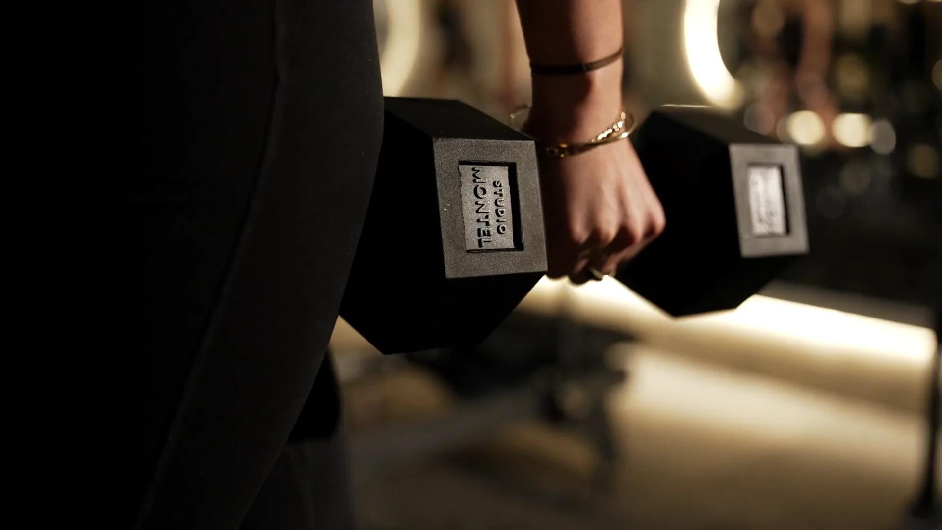 Dumbbells resting on a Strengthformer machine