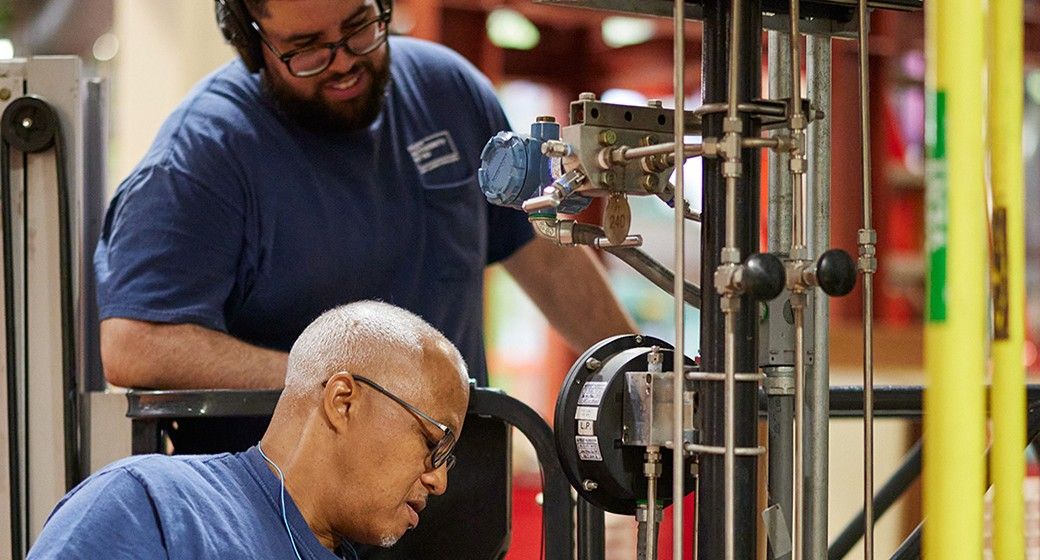 Industrial maintenance workers inspecting equipment inside a facility