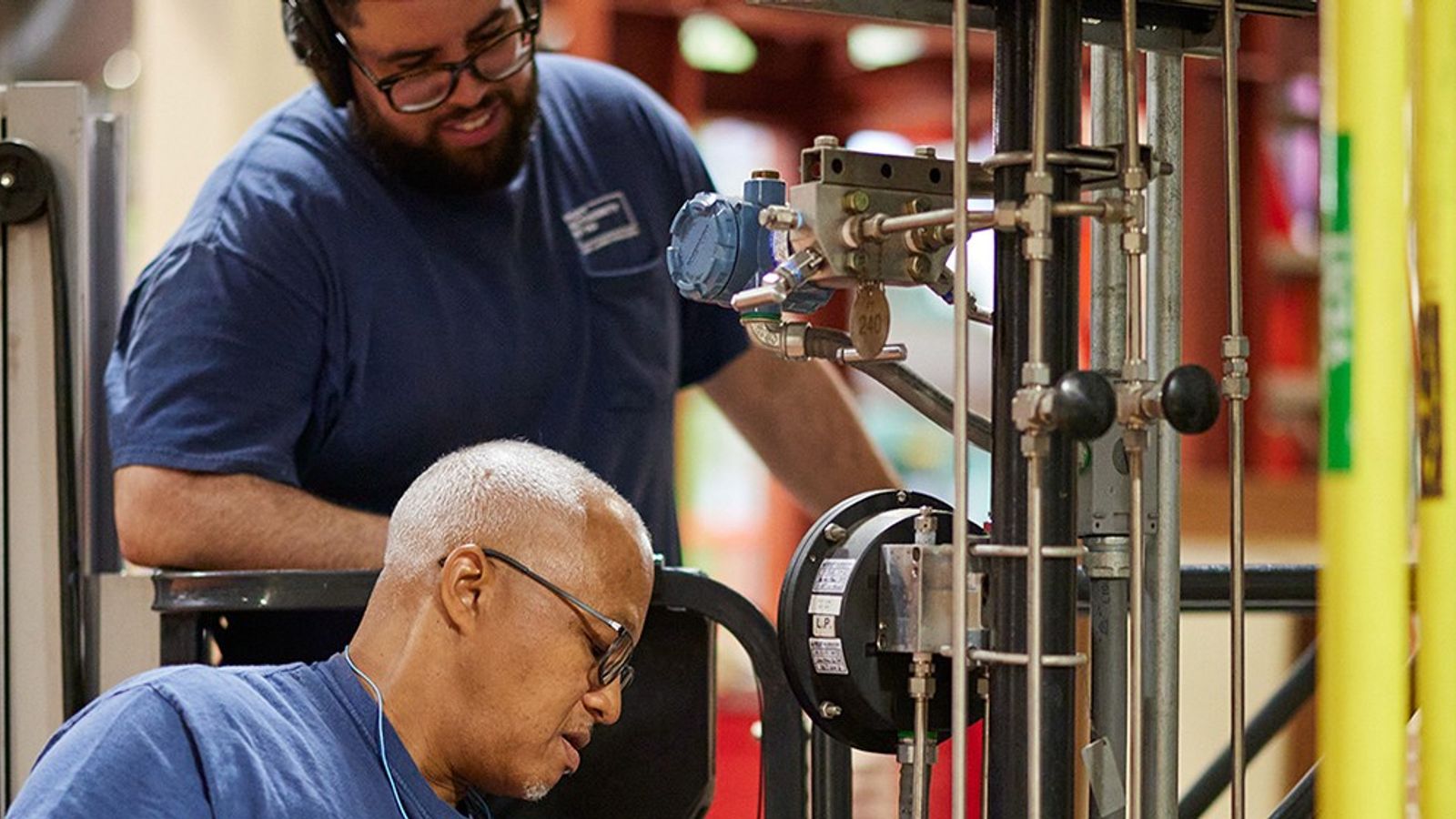 Industrial maintenance workers inspecting equipment inside a facility
