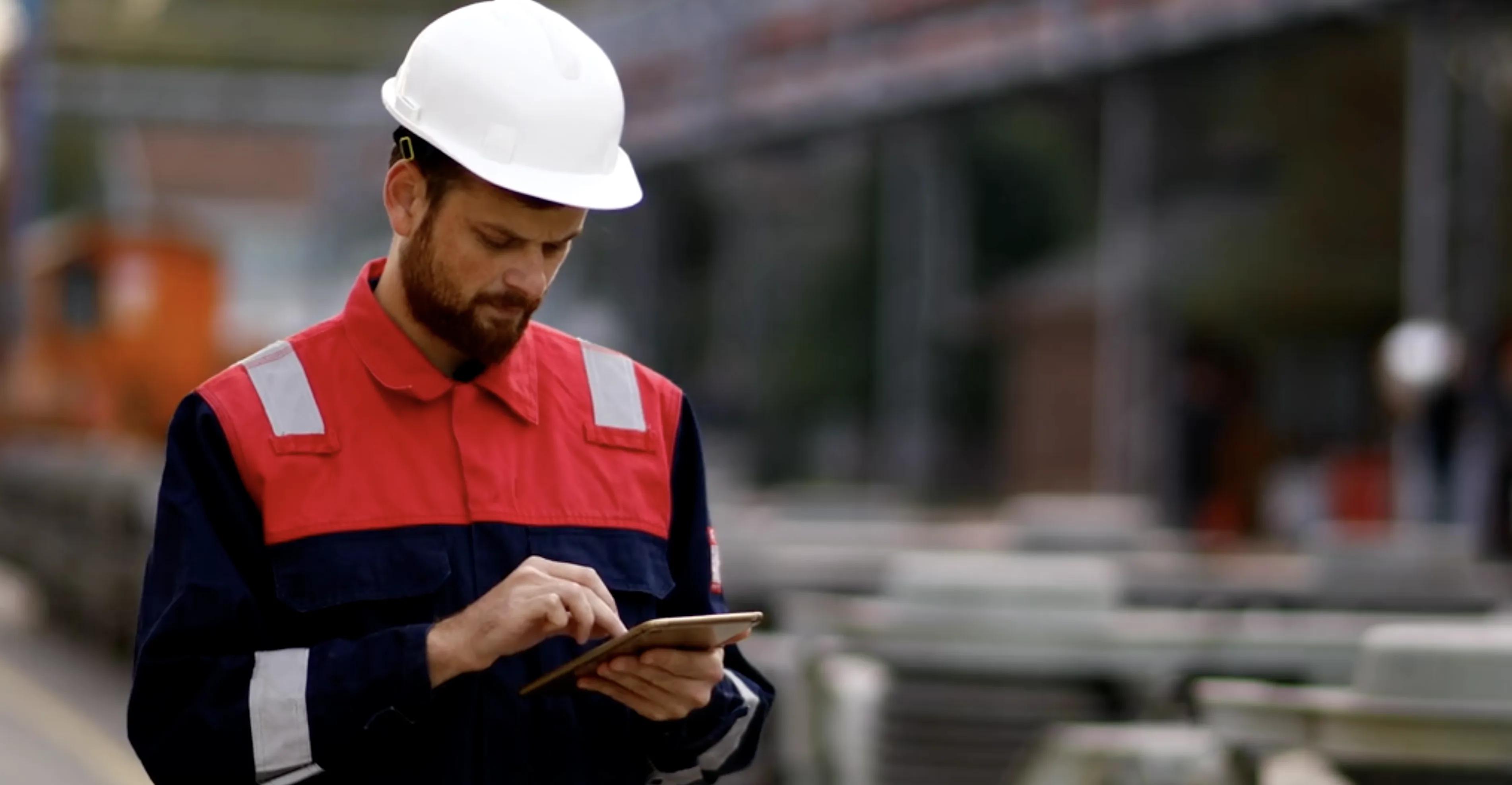 Industrial worker using a tablet at a job site