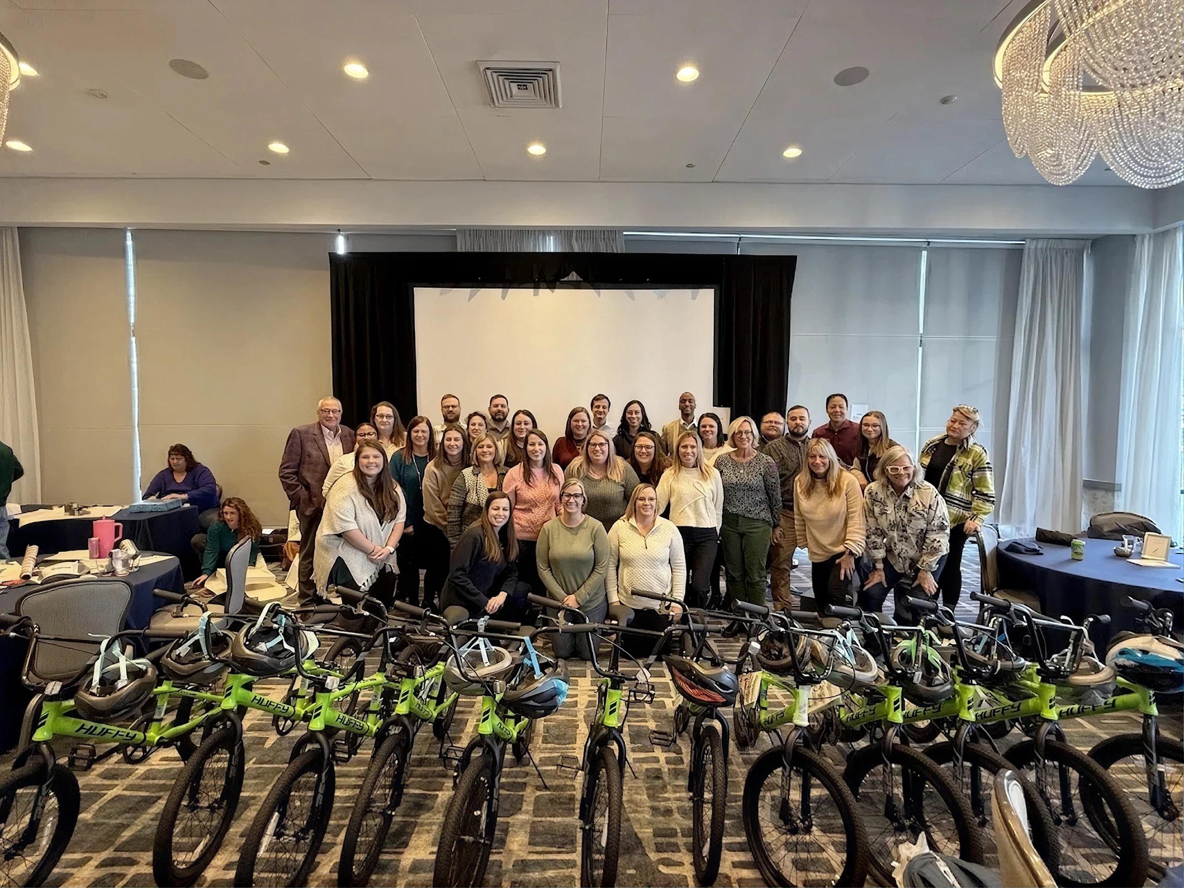 NXTThing team gathered behind bicycles assembled for a community service project